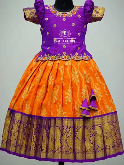 Another look at the orange and purple Banarasi lehenga, showing the puff sleeves and cute tassels.