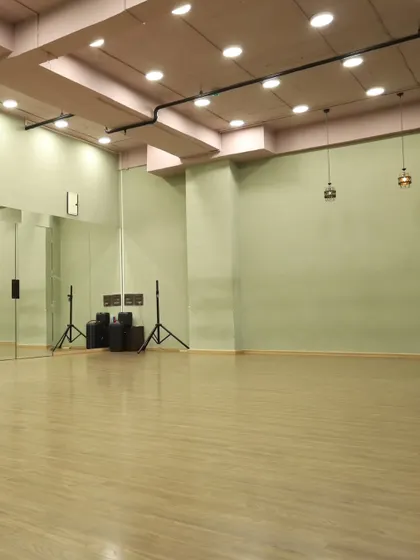 Another angle of our spacious studio, highlighting the professional speakers and open floor plan, ideal for workshops and classes.
