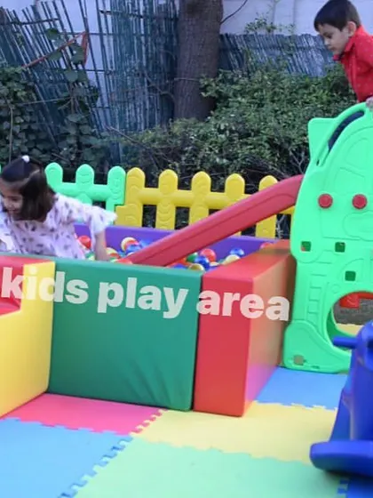 Kids having a great time on the climber and slide that leads into our colorful ball pit.
