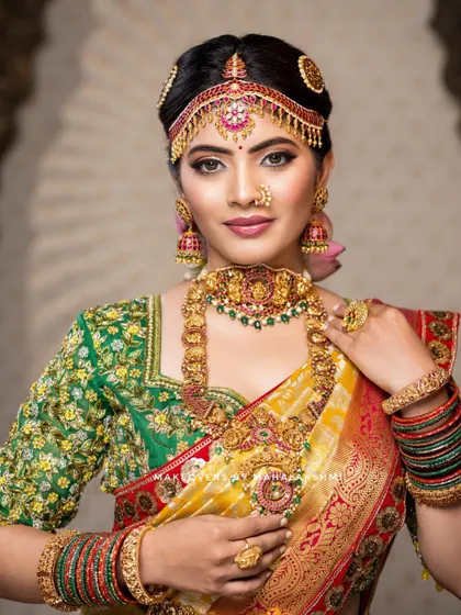 This detailed photoshoot showcases a complete South Indian bridal look, from the intricate matha patti and layered necklaces to the flawless airbrush makeup and traditional saree draping.