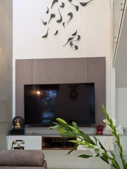 The custom 3D bird sculpture is a central artistic feature, creating a sense of movement and freedom against the clean lines of the TV panel.
