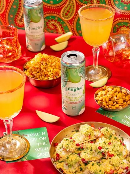 A vibrant shot pairing green mango cocktails with Indian chaat, creating a colorful and mouth-watering image.