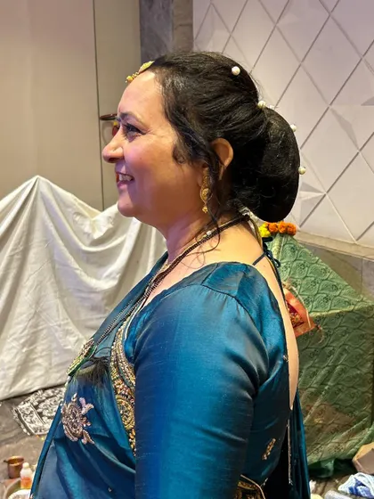 A side view of the elegant bun, showing the neat finish and placement of the accessories.