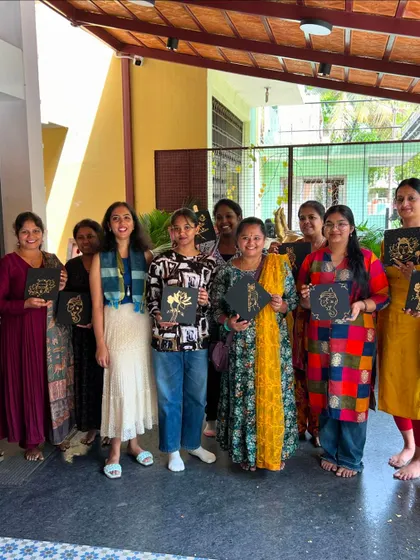 Participants from our gold foiling workshop proudly show off their shiny creations. This technique adds a touch of elegance to any artwork.