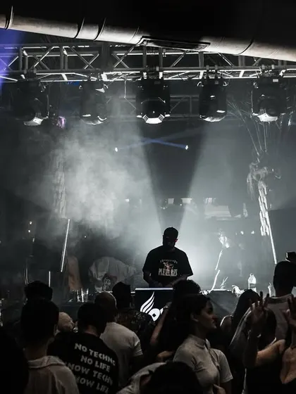 A wide shot of me performing in a large, packed venue. This image showcases my ability to handle big rooms and create an atmosphere that fills the entire space.