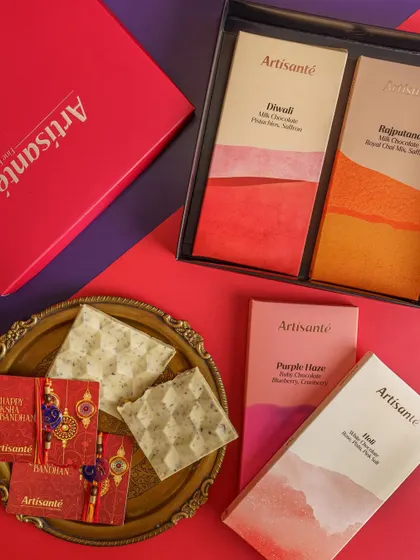 A colorful and modern product shot for a Rakhi campaign, featuring Artisanté's festive chocolate collection. The bold background and clean arrangement make the products pop.
