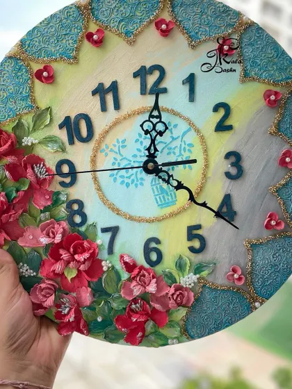 This 14-inch clock combines a multi-toned base with bold, dark numerals and deep red sculpted roses. The central design features a birdcage motif, adding a touch of whimsy to the classic floral theme.