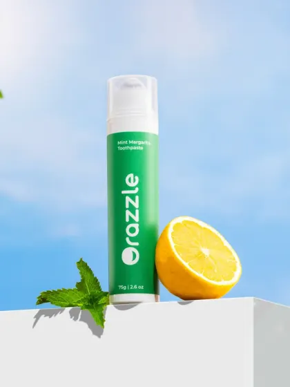 A refreshing outdoor shot for Orazzle toothpaste. We placed the product against a bright blue sky backdrop with fresh mint and lemon to evoke a feeling of natural freshness and energy.