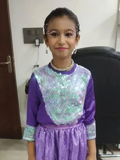 A full view of the themed makeup for this young dancer. The sequined outfit and the crystal eye makeup create a magical and coordinated look.