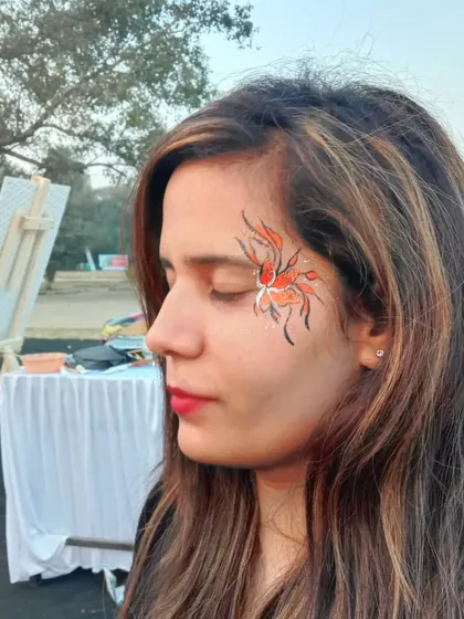 This abstract flower or butterfly design uses orange and white with delicate black lines, creating a fiery, energetic look.
