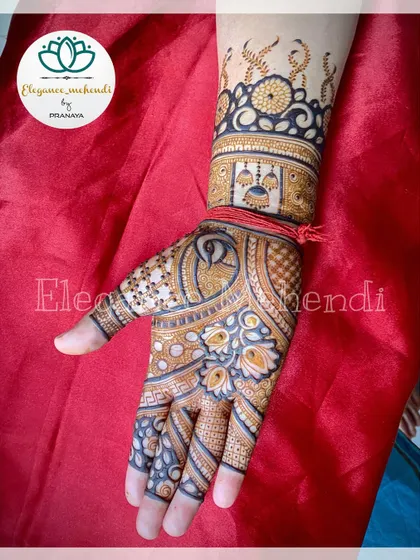 A beautiful design with jhumka (earring) motifs and peacock elements, perfect for a festive look.