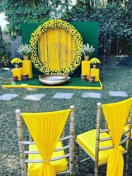 Another view of the outdoor Haldi setup, showing the guest seating with matching yellow chair decor. I ensure the entire event space is cohesive and beautifully styled.