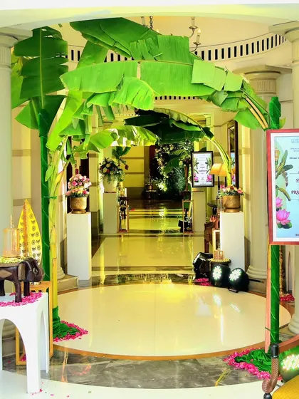 A beautiful outdoor entrance featuring an arch made of banana leaves, a symbol of prosperity and welcome in South Indian culture. This design creates an authentic and serene atmosphere for a traditional wedding.