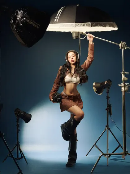 A behind-the-scenes style shot from our Y2K series. The model is posed with my actual studio lighting, blurring the line between the photoshoot and the final image.