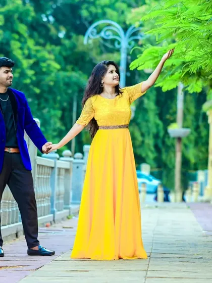 A sweet moment of connection. The bright yellow of her gown and the deep blue of his blazer create a striking color combination.