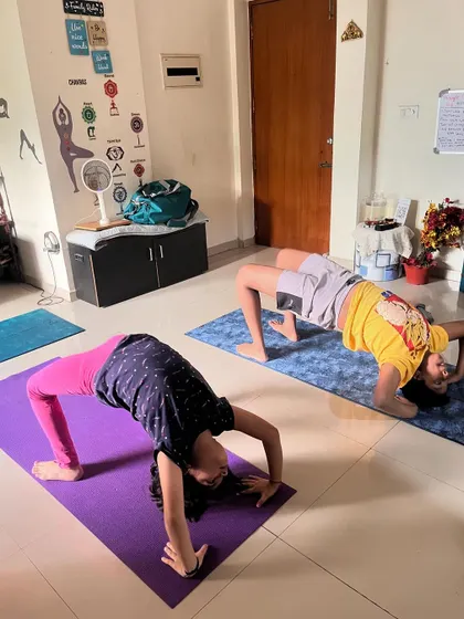 A duplicate of image 280, showing two kids in different backbend variations, highlighting individual progress.