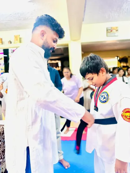 Awarding a black belt, the culmination of years of hard work, discipline, and perseverance.