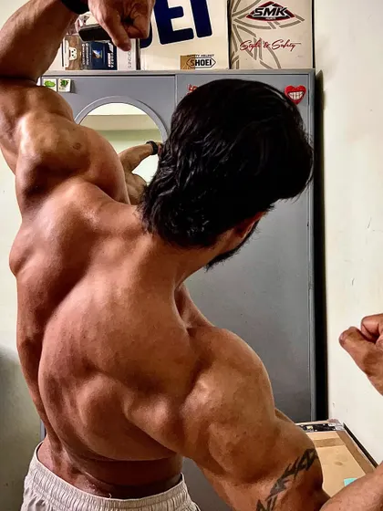 Another variation of the back pose, showing the results of a consistent and intense training regimen.