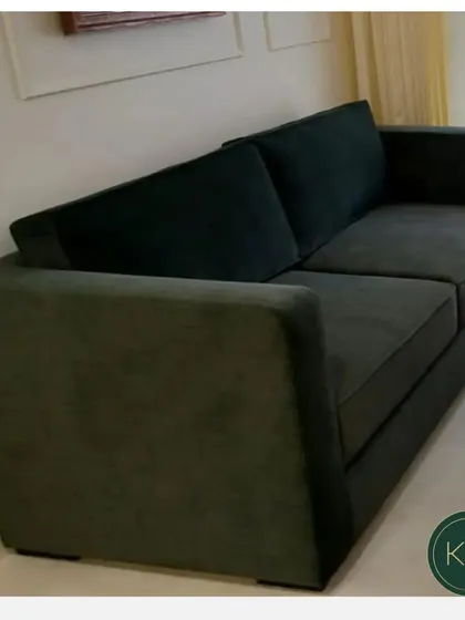 A simple yet elegant two-seater sofa in a deep forest green velvet. Its clean silhouette and wide arms make it a comfortable and timeless piece suitable for both residential and commercial lounge areas.