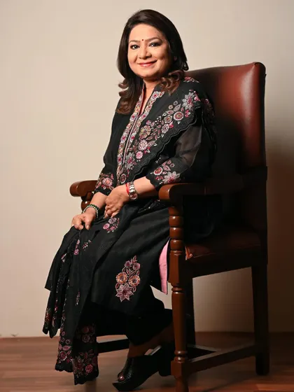 A classic seated portrait against a neutral background. This timeless shot focuses on the subject's expression and elegant attire, perfect for a variety of professional uses.