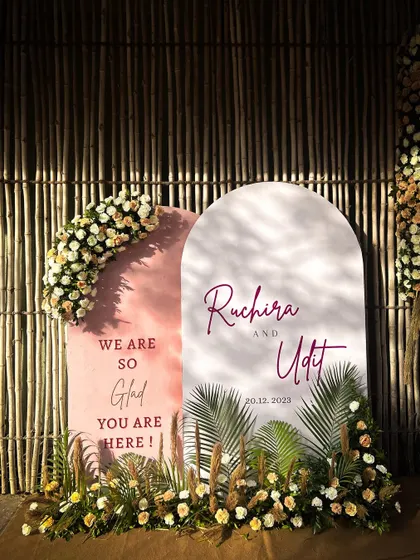 A simple and elegant welcome sign for a beachside wedding in Alibaug, adorned with pampas grass and florals to match the bohemian theme.