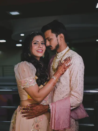 An elegant evening portrait of a couple in pastel traditional wear.
