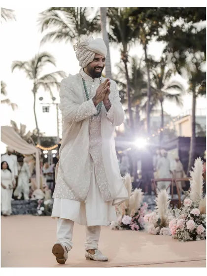 The groom's energetic entrance at his beach wedding in Thailand.