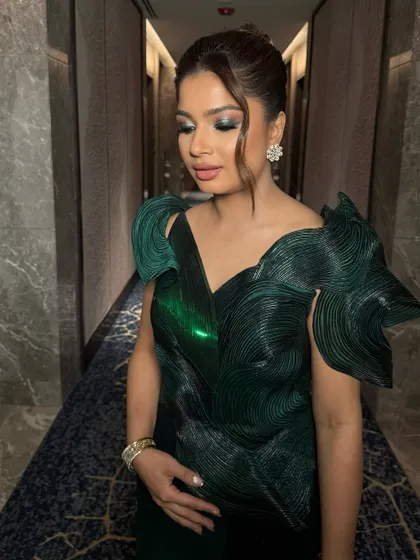 A close-up of the green chrome eyes. This is a great way to add a modern, edgy touch to an evening look while still keeping it elegant and sophisticated.