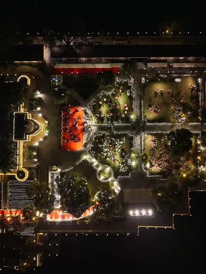 A spectacular drone view of the garden setup at Jagmandir, showing the intricate layout of lights and decor that transforms the island at night.