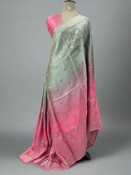 A unique shaded satin saree blending from pastel green to pink.