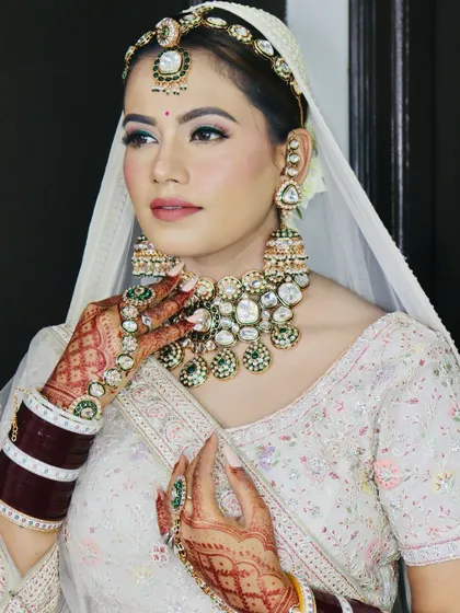 A side profile that showcases the elegant hairstyle and the stunning jewelry.