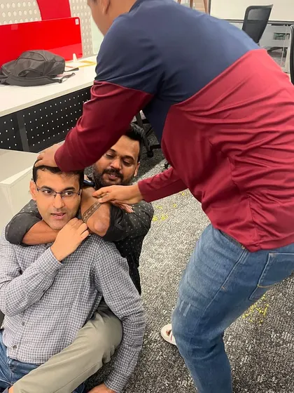 Another group practices escaping a chokehold. Repetition and hands-on practice are key to building muscle memory.