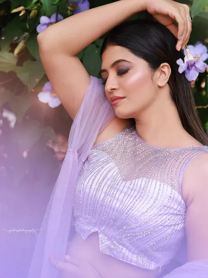 A designer shoot for a modern lavender lehenga. The images were taken in a lush garden, with the purple flowers complementing the color of the outfit, creating a soft and romantic fashion story.