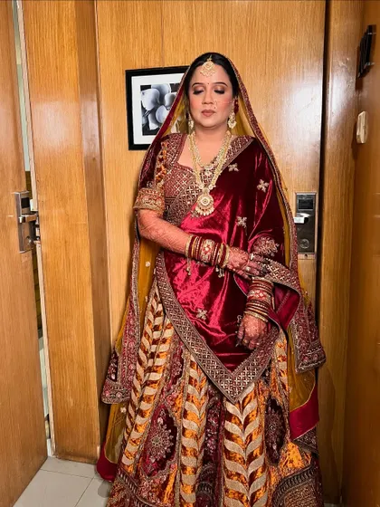 A serene portrait, with eyes closed to show the soft and subtle eye makeup that complements the heavy outfit.
