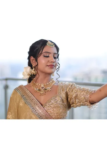 A serene moment, capturing the bride's peaceful happiness. The makeup is soft and glowing, perfect for this emotional day.