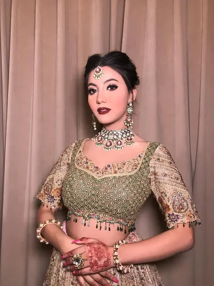 A model showcasing our "JW Madhu" set, a beautiful Polki choker with ruby-colored stones, paired with a matching maang tikka and earrings for a complete look.