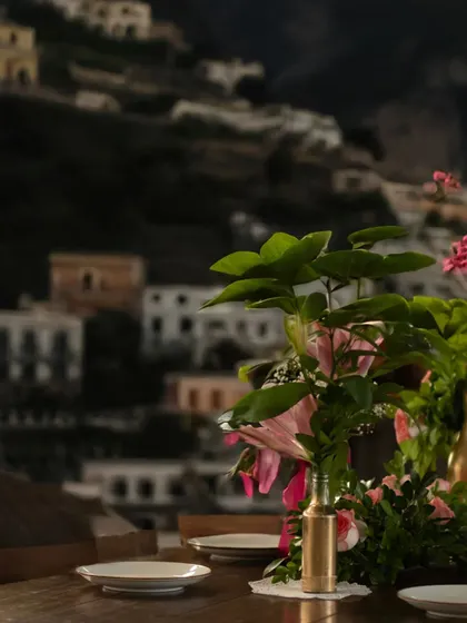 A detail of a table set against a mural of the Amalfi coast, a tribute to my origins. It’s these small, narrative details that add depth and curiosity to the dining experience.