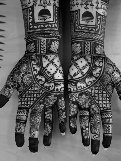 A black and white version of the intricate bridal mehendi, emphasizing the patterns and textures of the design.