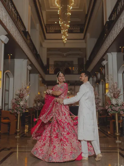A twirl in the grand lobby of a luxury hotel. The bride's magnificent lehenga and the stunning chandelier create a picture of pure elegance and celebration.