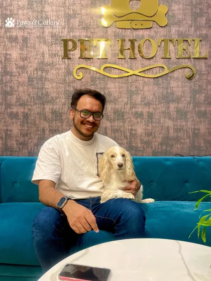 A happy pet parent and his dog relax in our stylish Pet Hotel lounge. We've created a welcoming space for both pets and their people.