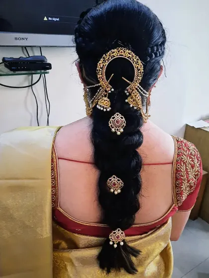 A clear, detailed shot of the traditional braid and the placement of the hair jewelry.