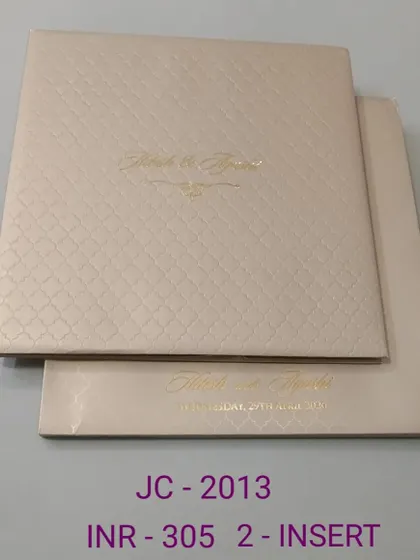 A premium and minimalist invitation with a textured, quilted pattern and simple gold foil names. This design is all about quiet luxury and sophistication.