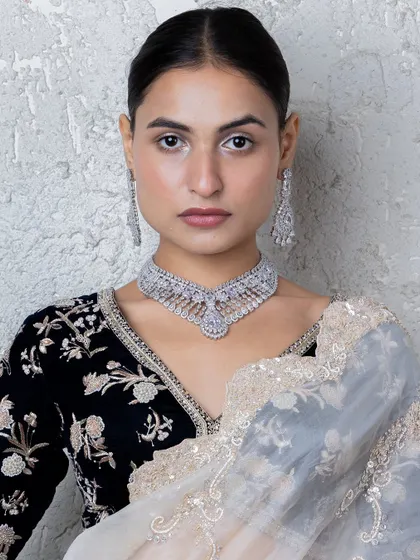 Our stunning all-diamond choker set, perfect for a glamorous reception or cocktail party. The intricate design showcases the brilliance of the American diamonds, creating a truly luxurious piece.