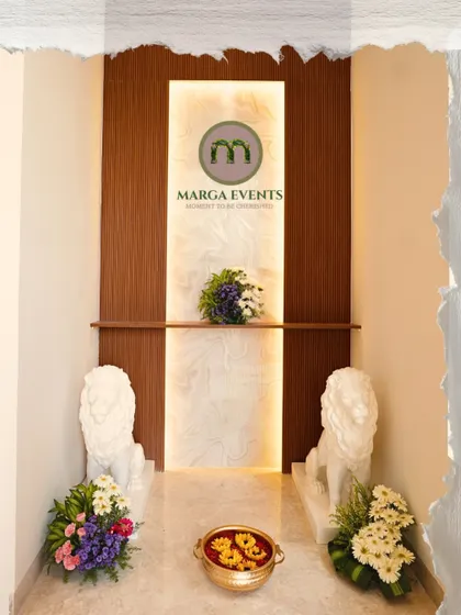 Even a simple entrance can be made elegant and welcoming. For this home, I used minimal floral arrangements paired with stately lion sculptures and a traditional urli with floating flowers to create a graceful first impression for guests.