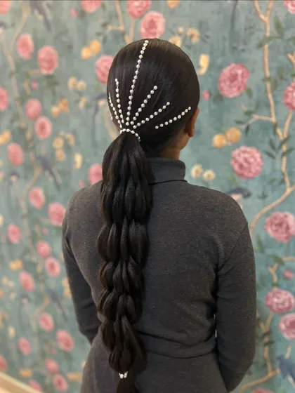 A still shot of the pearl starburst braid, a unique and elegant style perfect for a cocktail party.