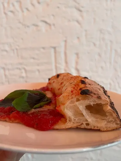 Just a single slice of our Marinara, showing off that beautiful, airy edge. Simplicity at its finest.