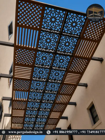 A view looking up at a custom CNC-cut pergola roof. The geometric pattern allows sunlight to filter through, creating a dynamic and visually interesting experience that changes throughout the day.