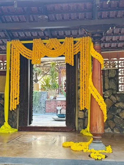 A bright and cheerful entrance for a Haldi ceremony, decorated entirely with yellow marigold flowers.