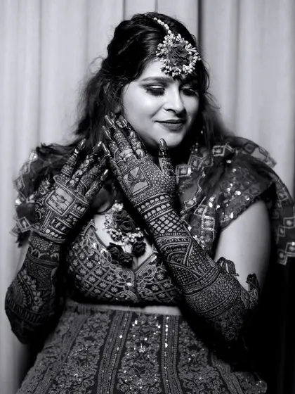 A timeless black and white portrait of the bride. This style emphasizes the emotion and the intricate patterns of her Mehndi.