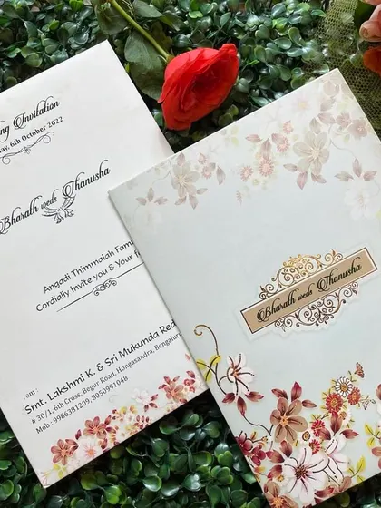 A lovely invitation with a border of autumn-colored flowers. The design is warm and inviting, perfect for a fall wedding.